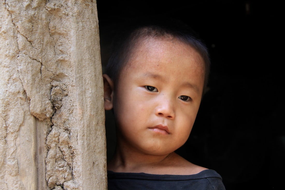 Sudip standing in the doorway to his home in Nepal