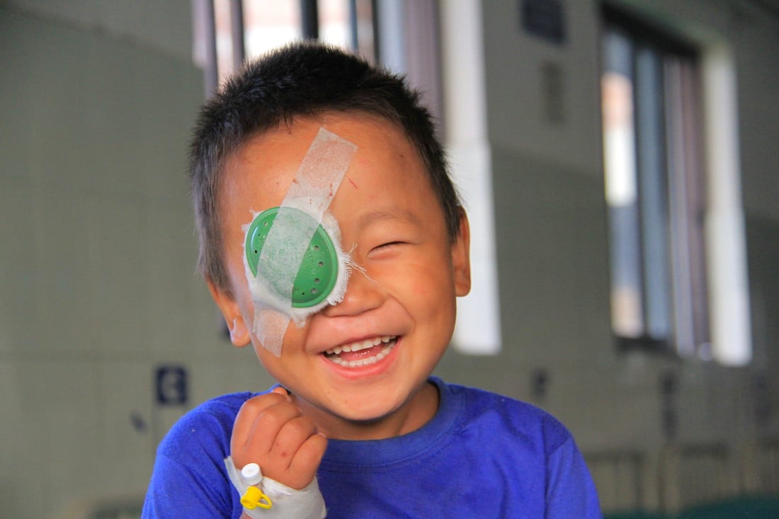 Sudip smiling and wearing an eye patch over his right eye after successful cataract surgery.