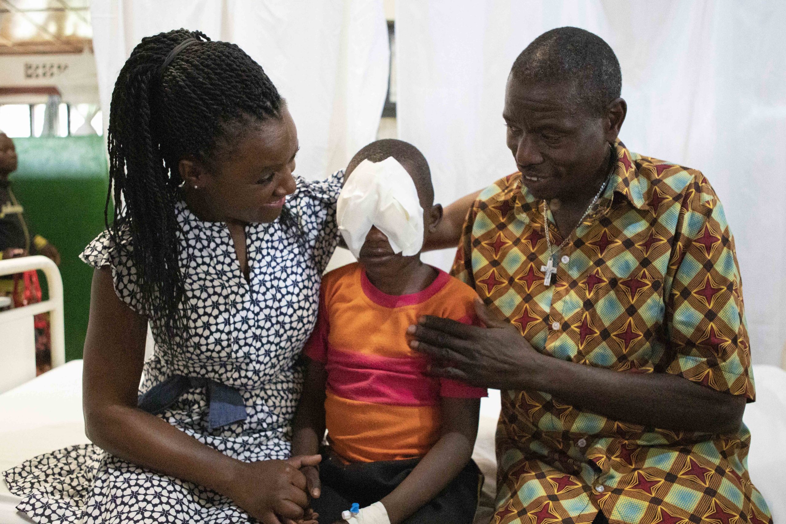 Diane sat with Etienne and his father, before his eye patches are removed