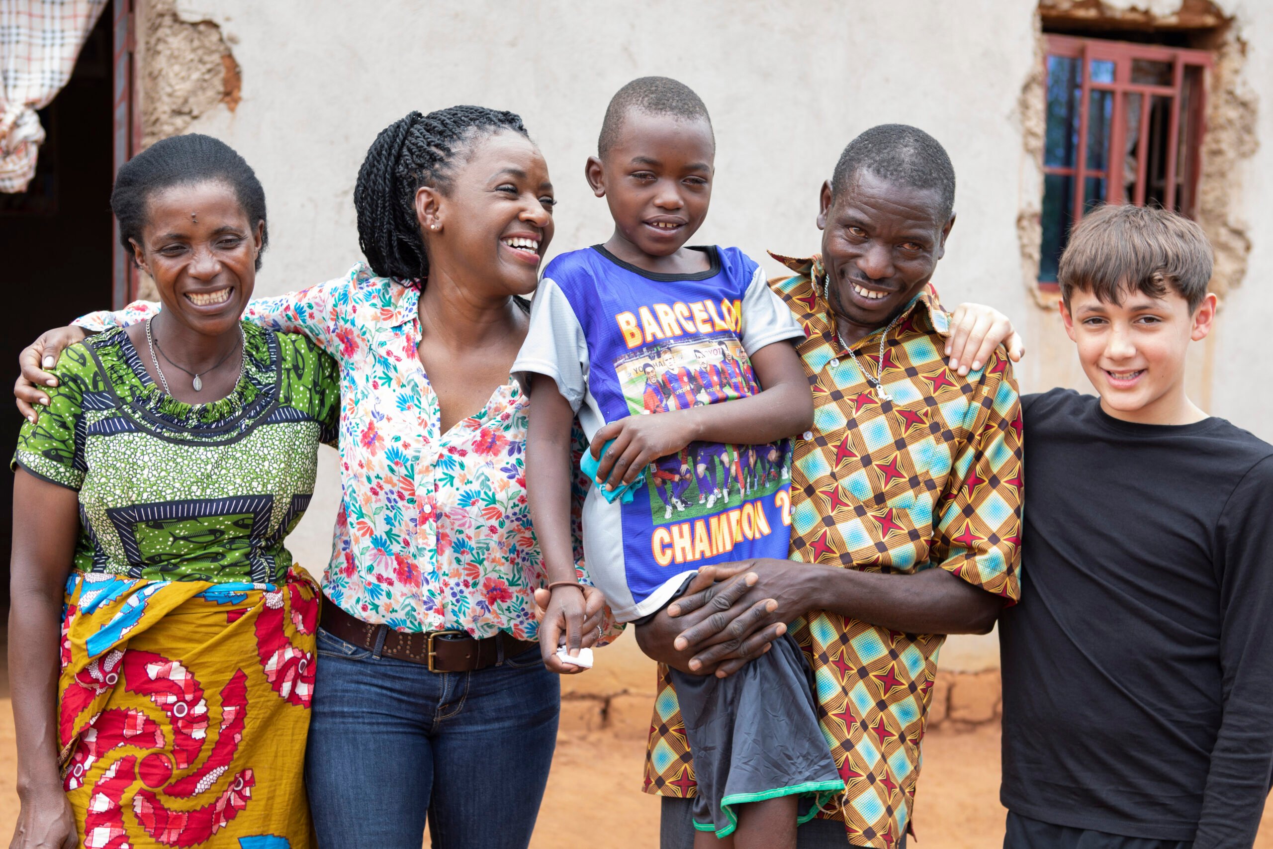 Diane and Preston with Etienne and his parents outside their house, all smiling