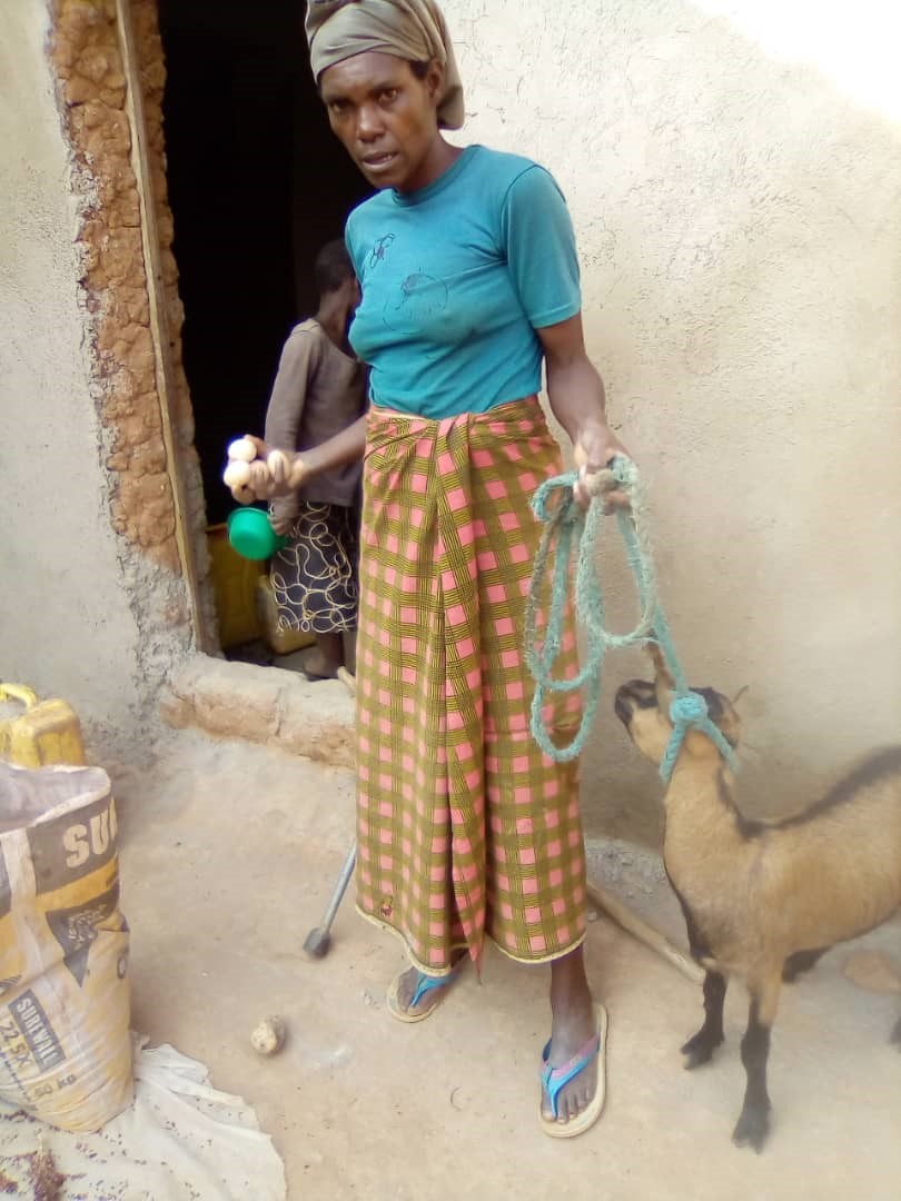 Agnesta at home, holding her goat on a lead.