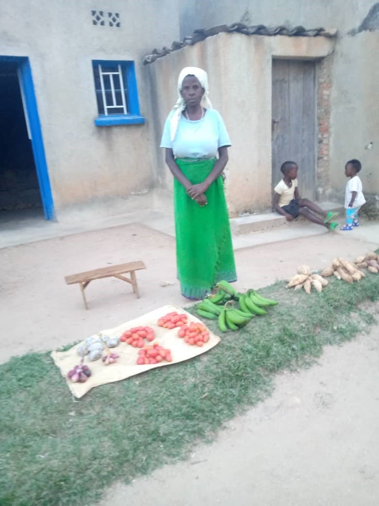 Ansilla selling her produce outside on a mat, including bananas.