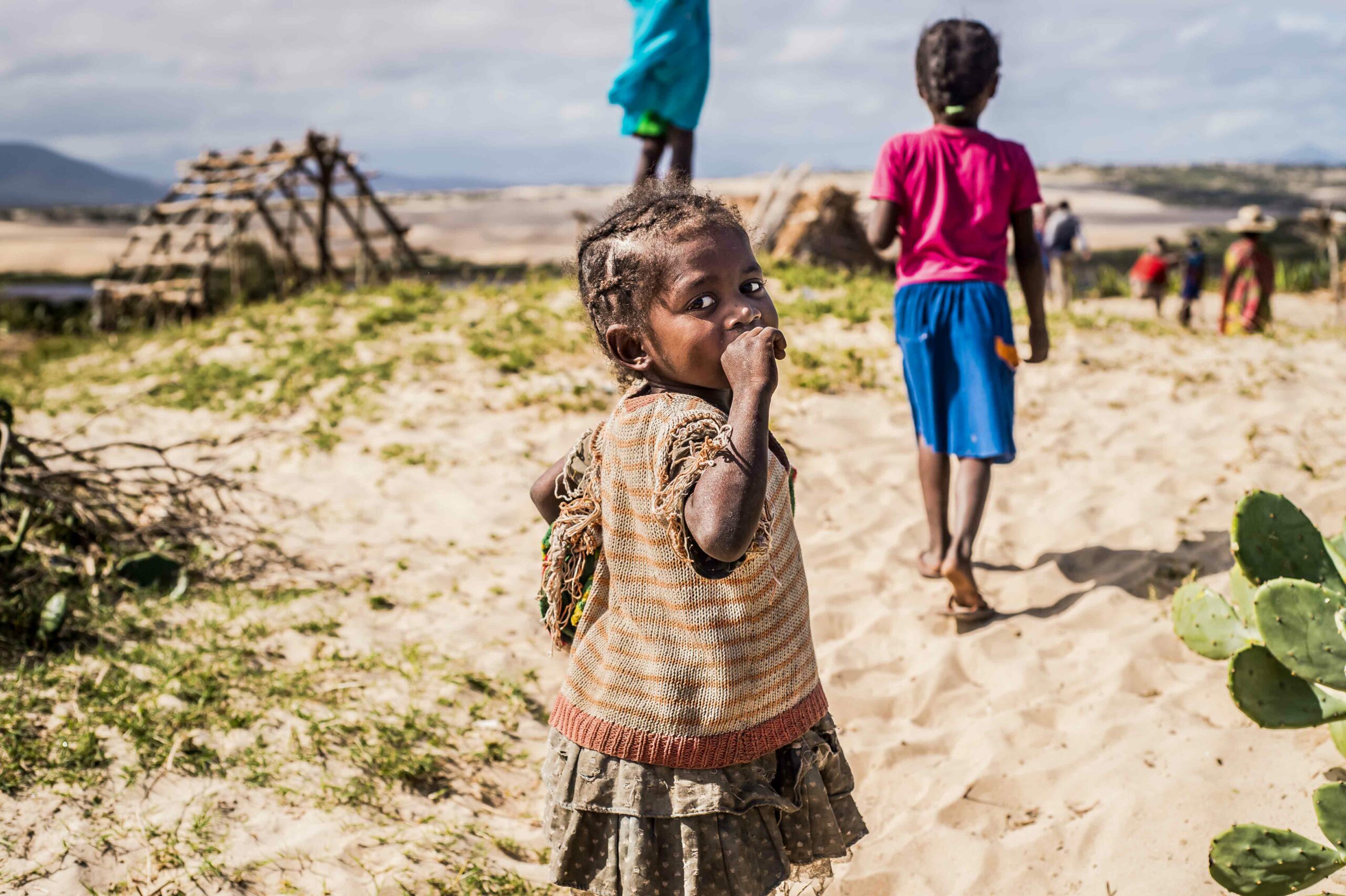 Child looking back towards the camera with desert in the background