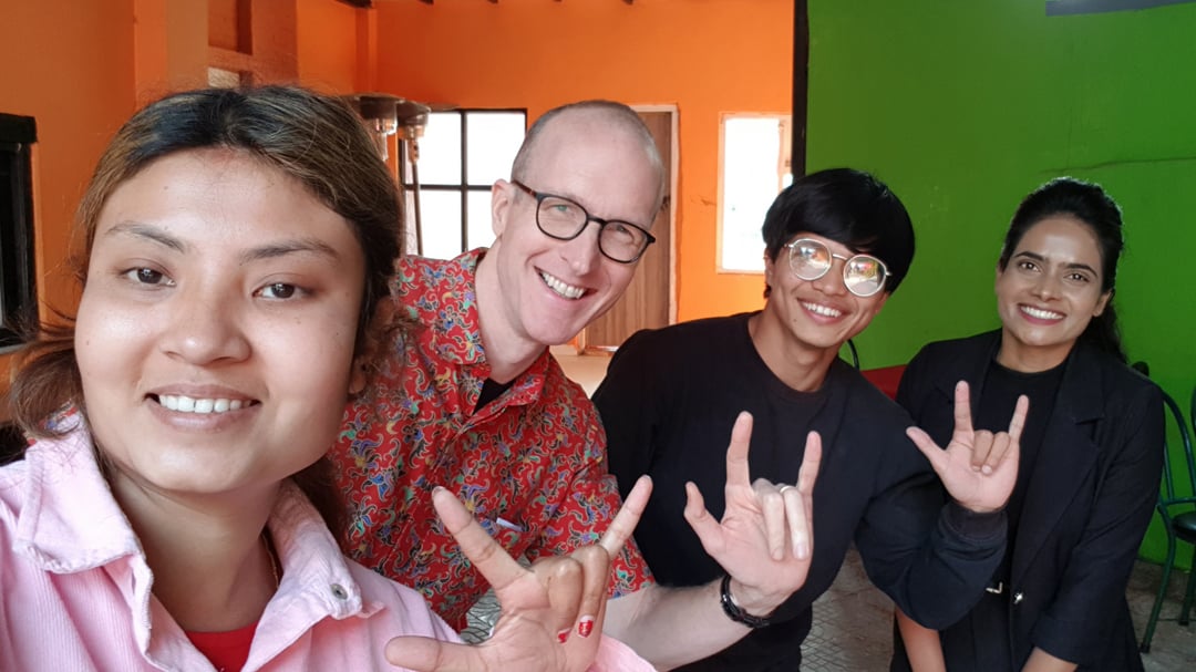 Matthew with BYAN colleagues with hands making sign language