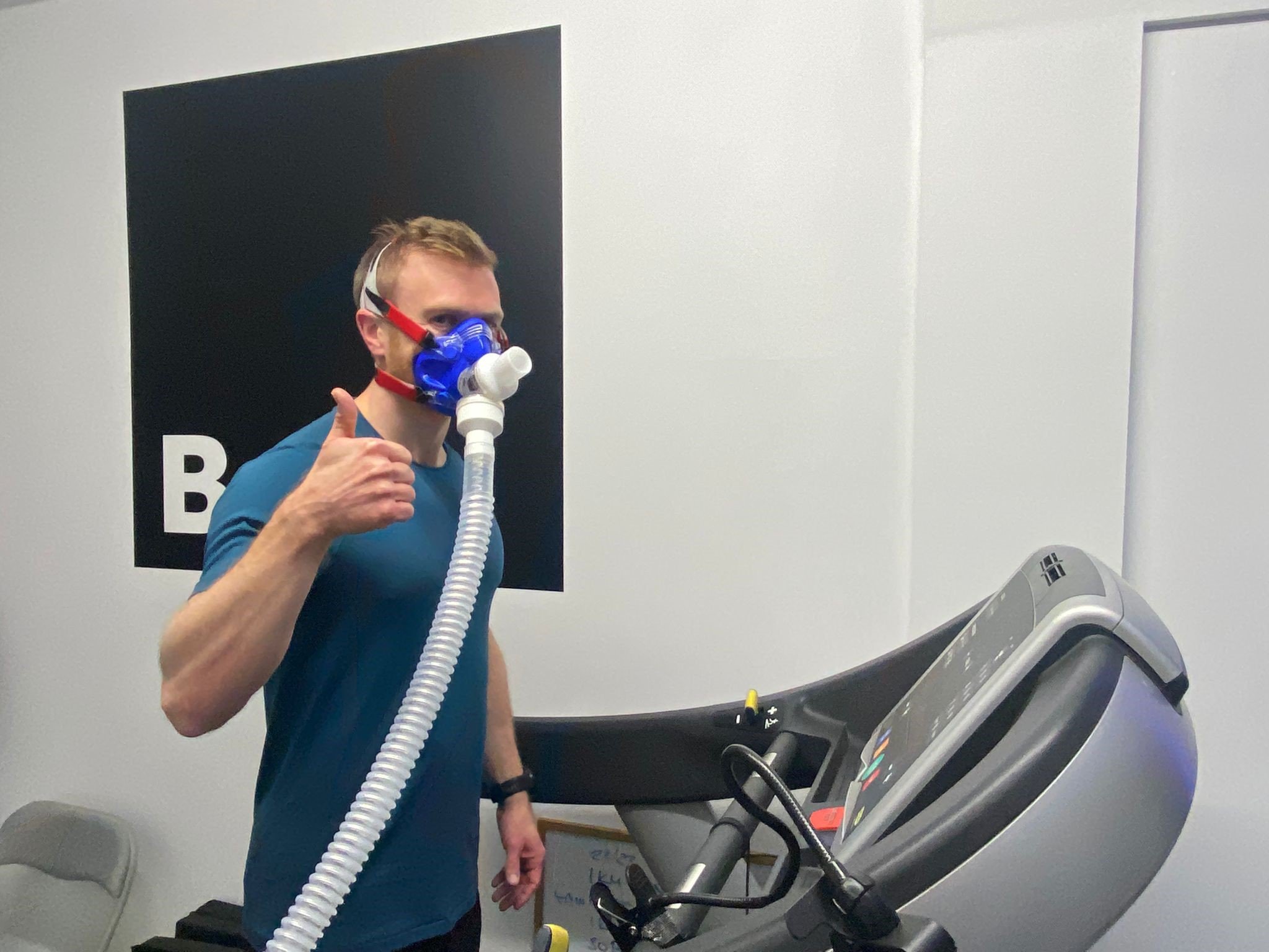 Ben wearing an oxygen mask and standing on a treadmill.