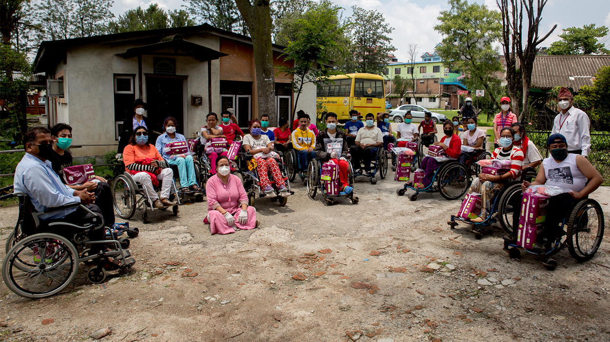 A large group of women in wheelchairs arranged in a semi-circle