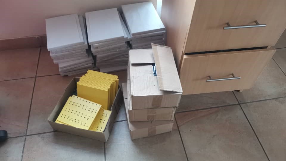 Boxes of braille learning and teaching resources.