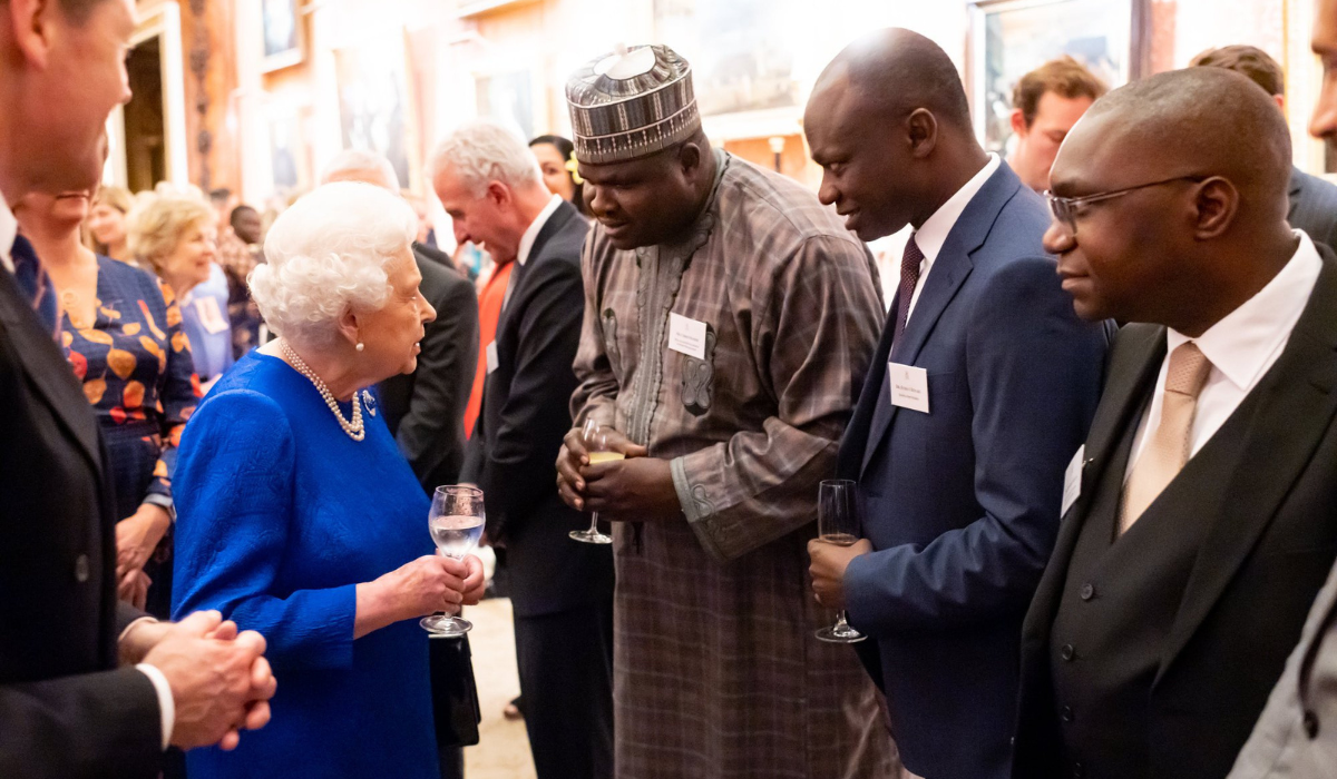 Chris Ogoshi meeting the late Queen at Buckingham palace.