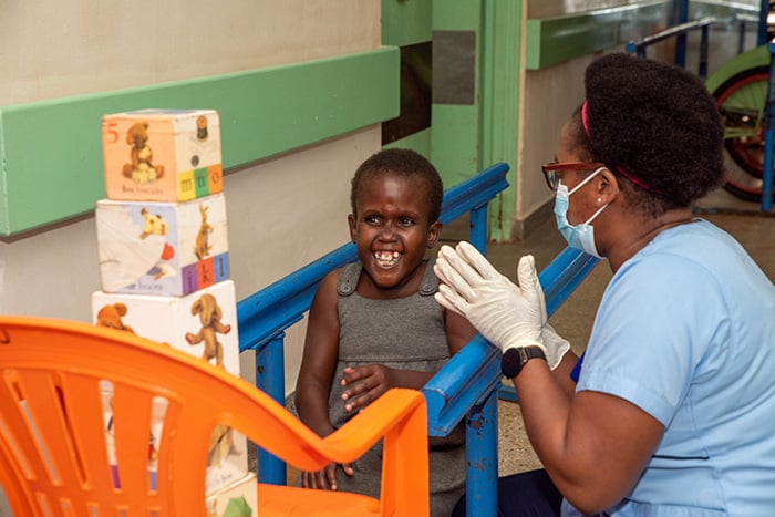Christine working with a child in walking physiotherapy