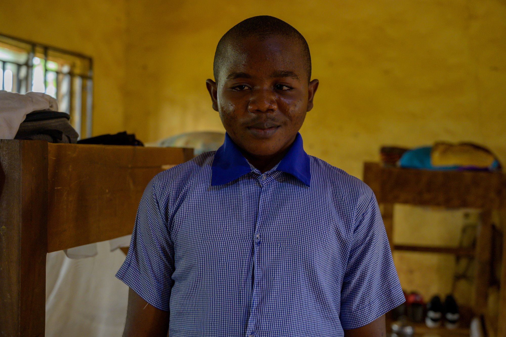 Close up of Possible, 19-year-old male student, standing in his classroom