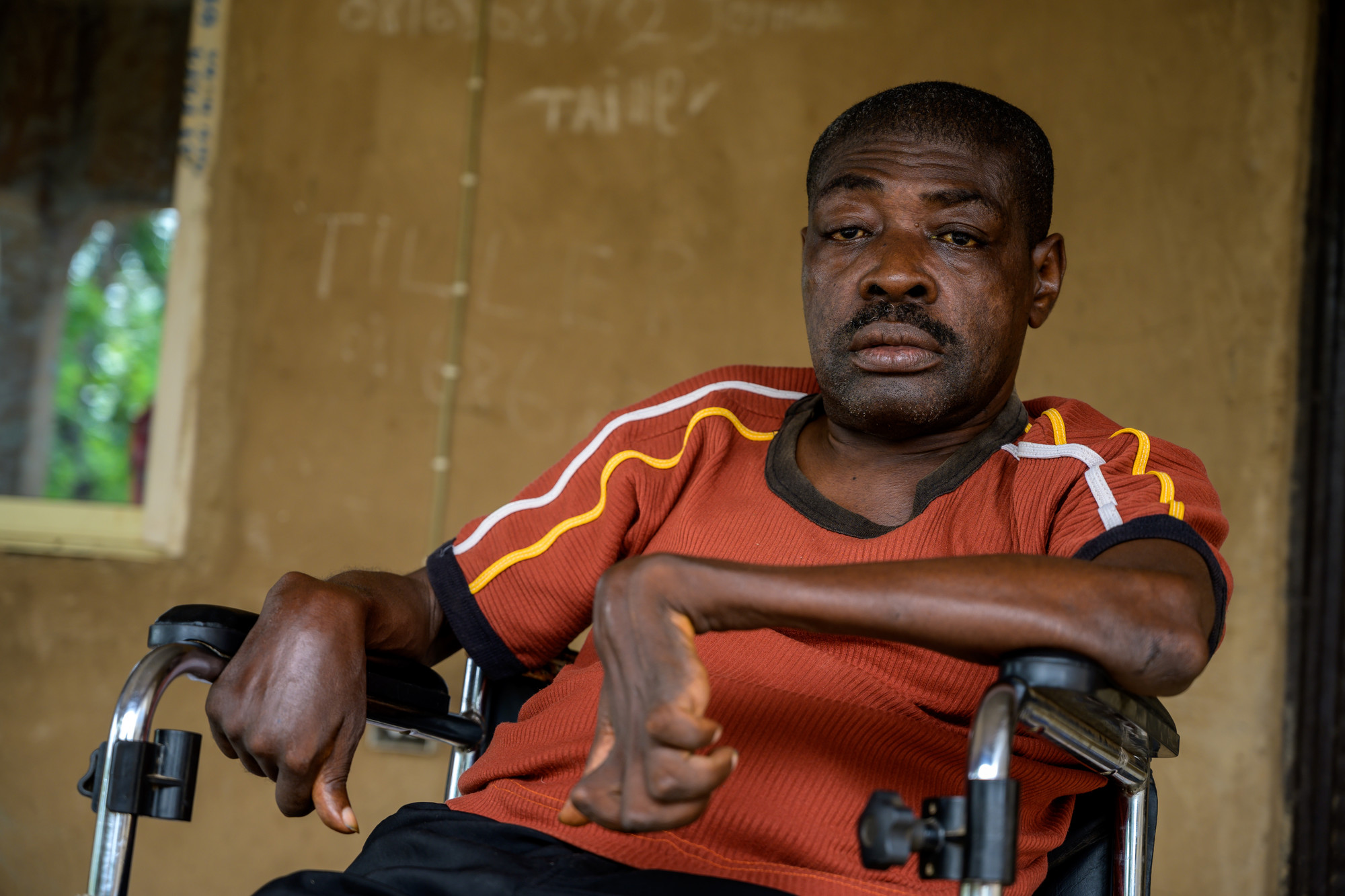 Paul sat outside his home in his wheelchair.