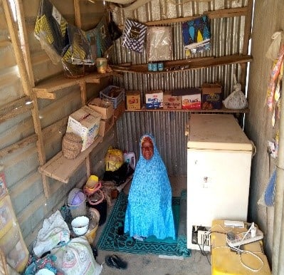 Hajiya showing some of the items she sells now her business has expanded.