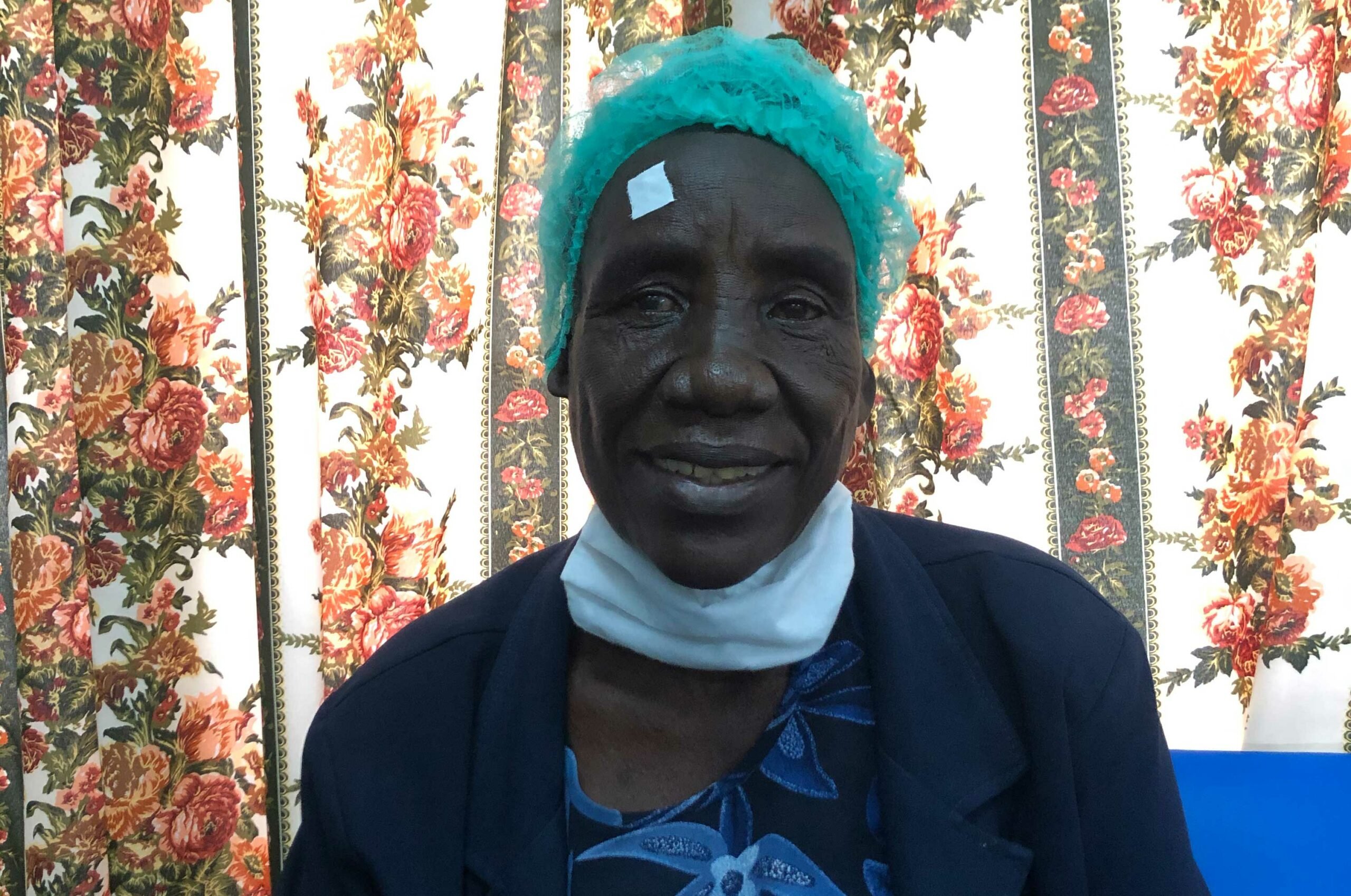 Female patient smiling as she waits for eye treatment