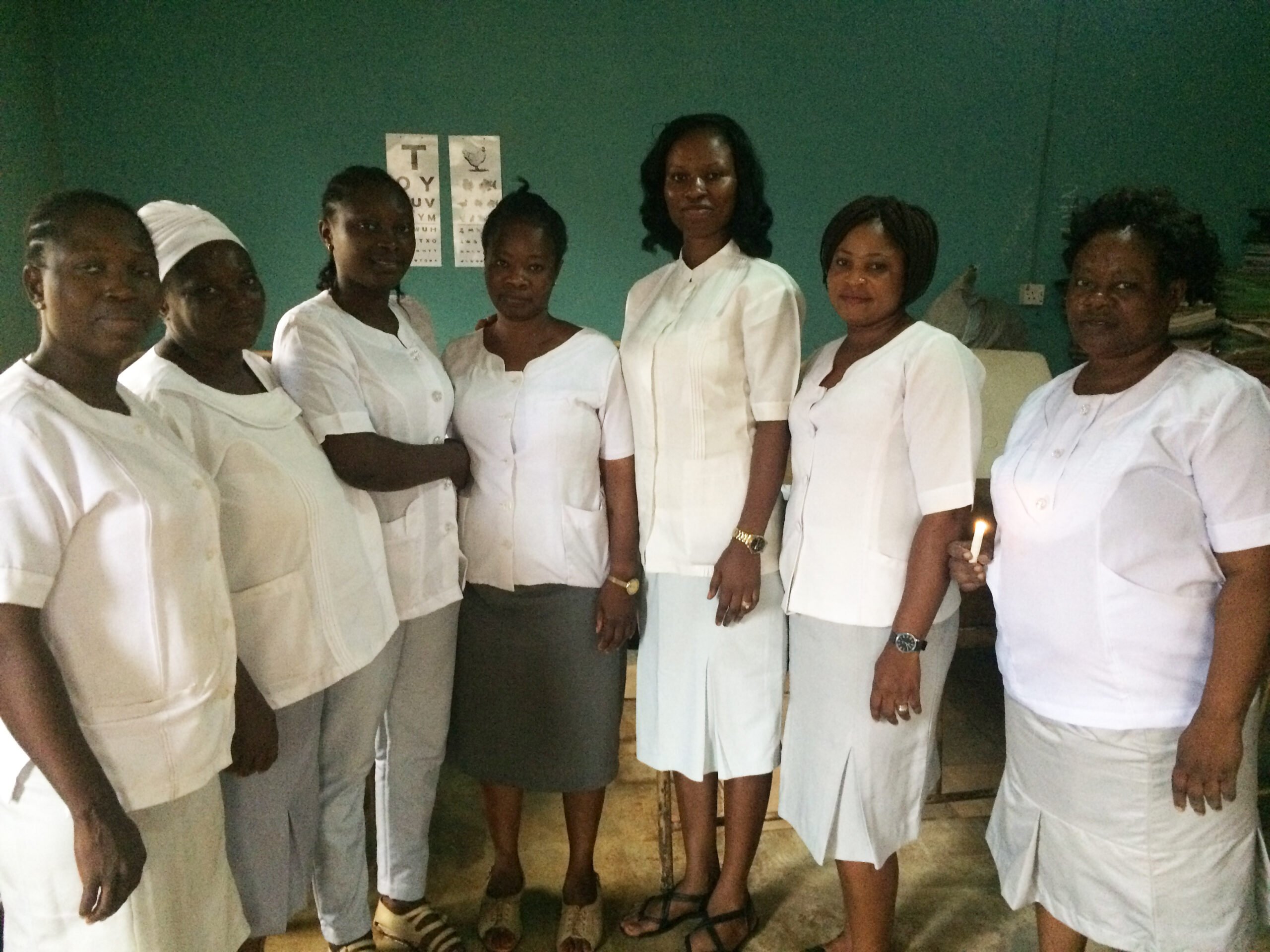 Community Health Workers at Apete Primary Health Centre wearing white clothes and standing in a line.
