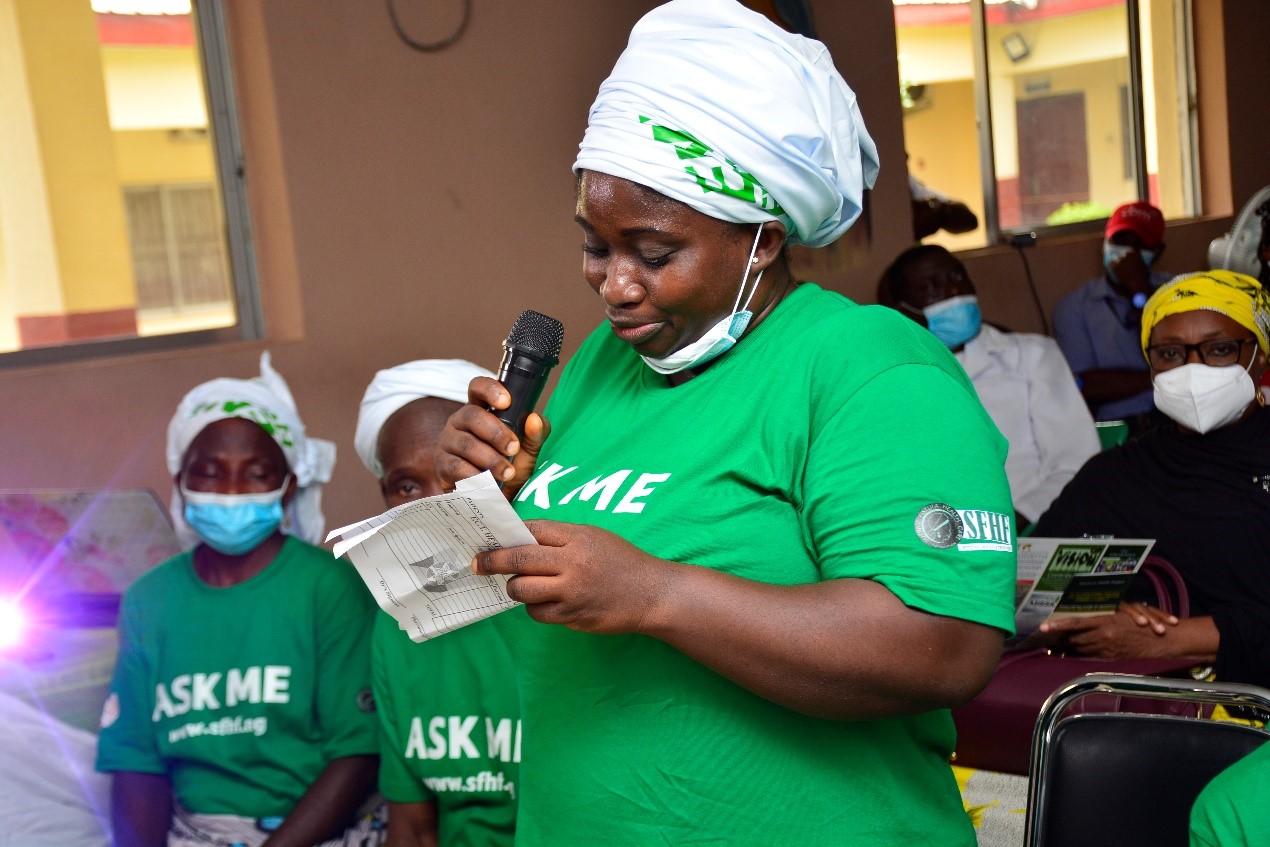 Jamilat (28) speaking at an event at he Survive Fistula Healthcare Foundation in Nigeria., wearing a green t-shirt.