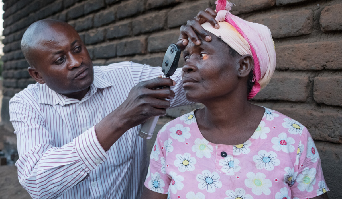 Eye health worker examines eyes of woman with trachoma