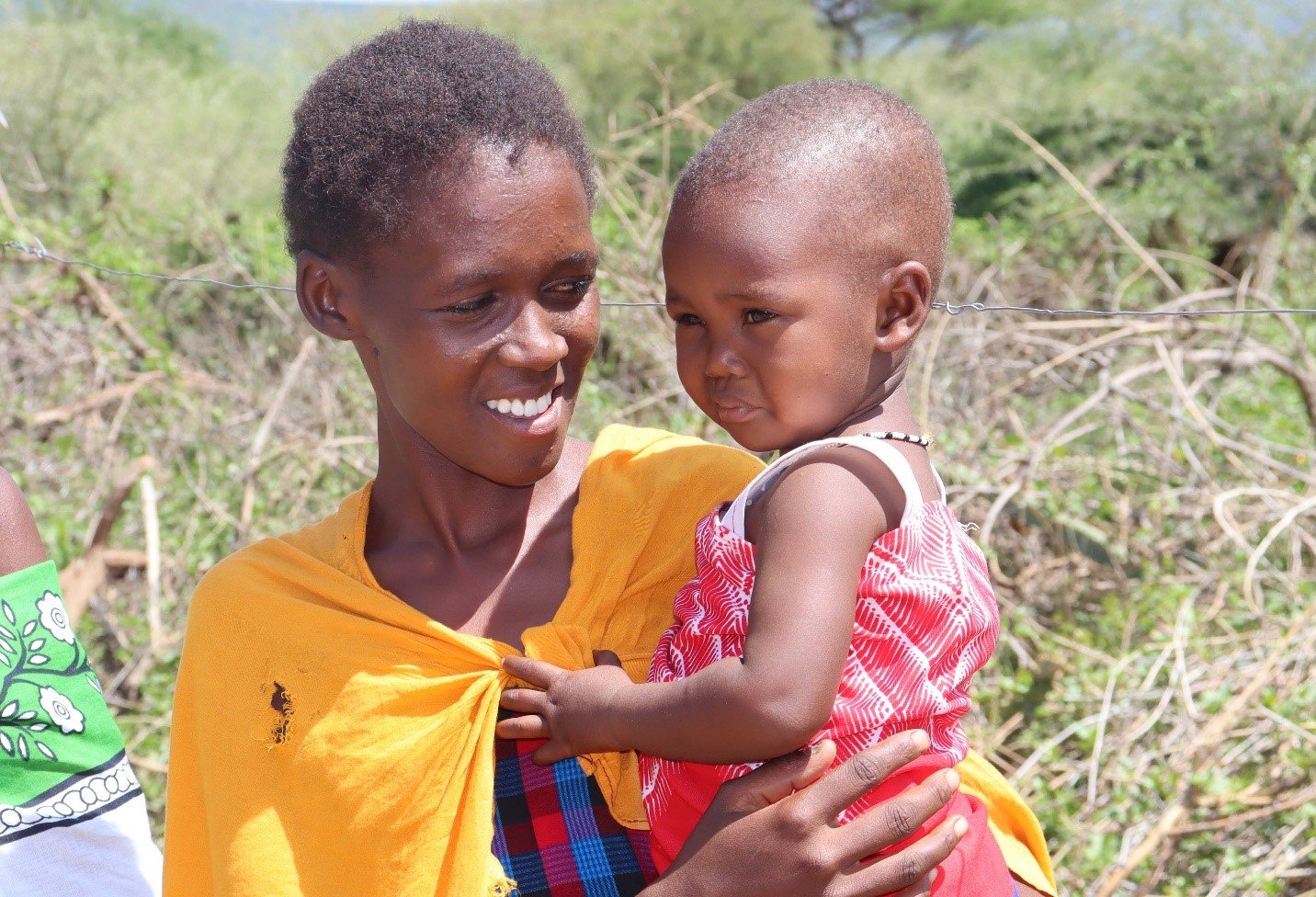 Women holding and looking at her toddler.