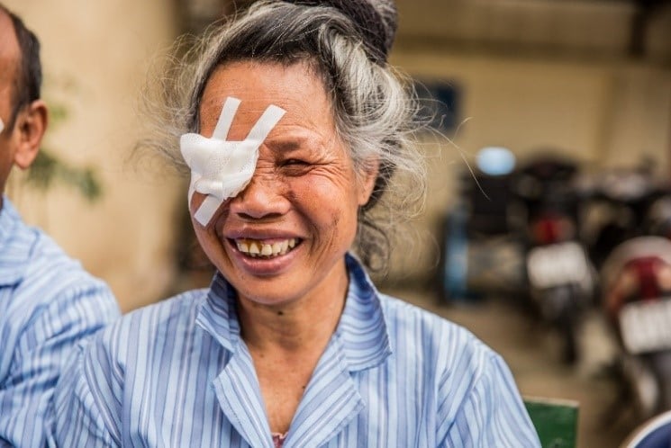 Pom at hospital, smiling with an eye patch over her right eye.