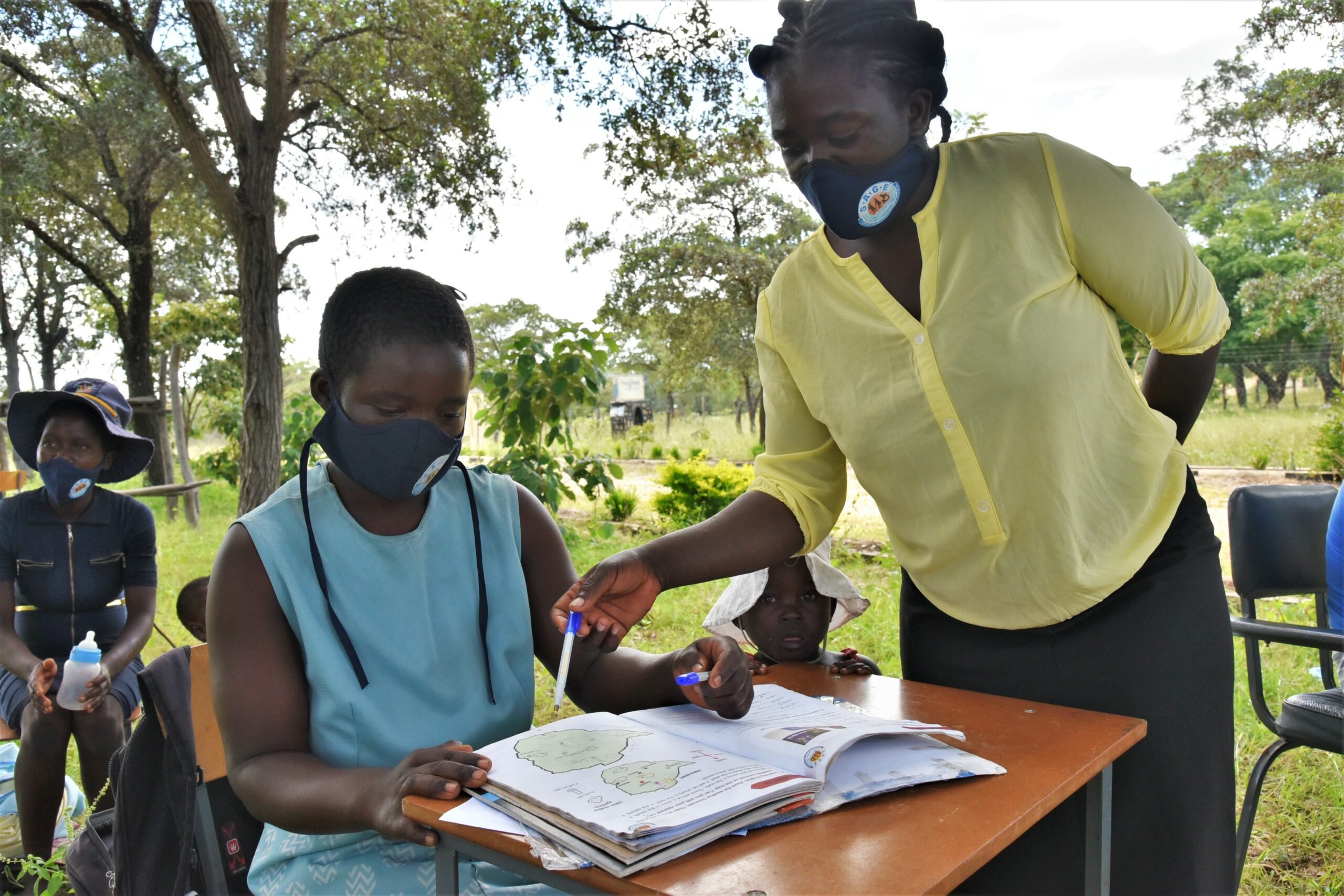 Susan being taught at a learning hub outside 