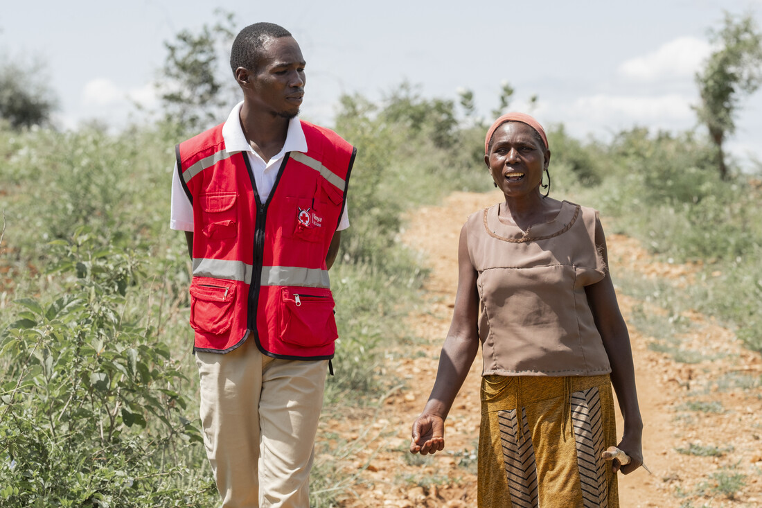 Sofia walking with a health worker.