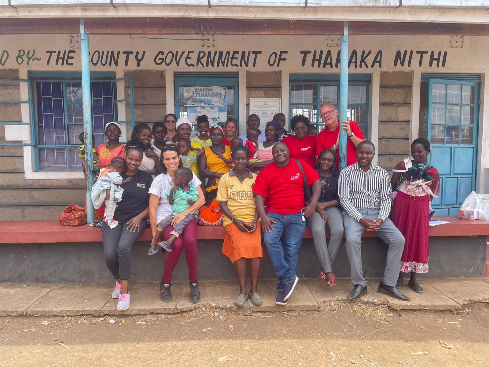 Staff from CBM UK, CBM Kenya, Kenyan partner DOM Spark, Nous Cims and the County Nutritionist standing at the Gaceuni health clinic in Tharaka Nithi. 