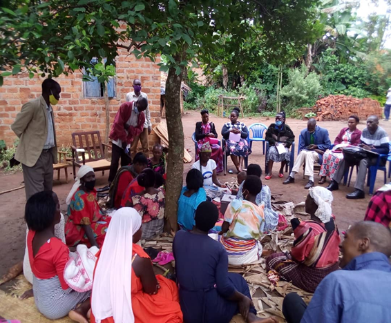 Twekebe VSLA group meeting outside beneath a tree