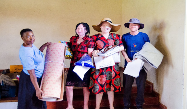 ZIMAS staff handing over learning materials to some of the youths at Ruwa Rehabilitation Centre