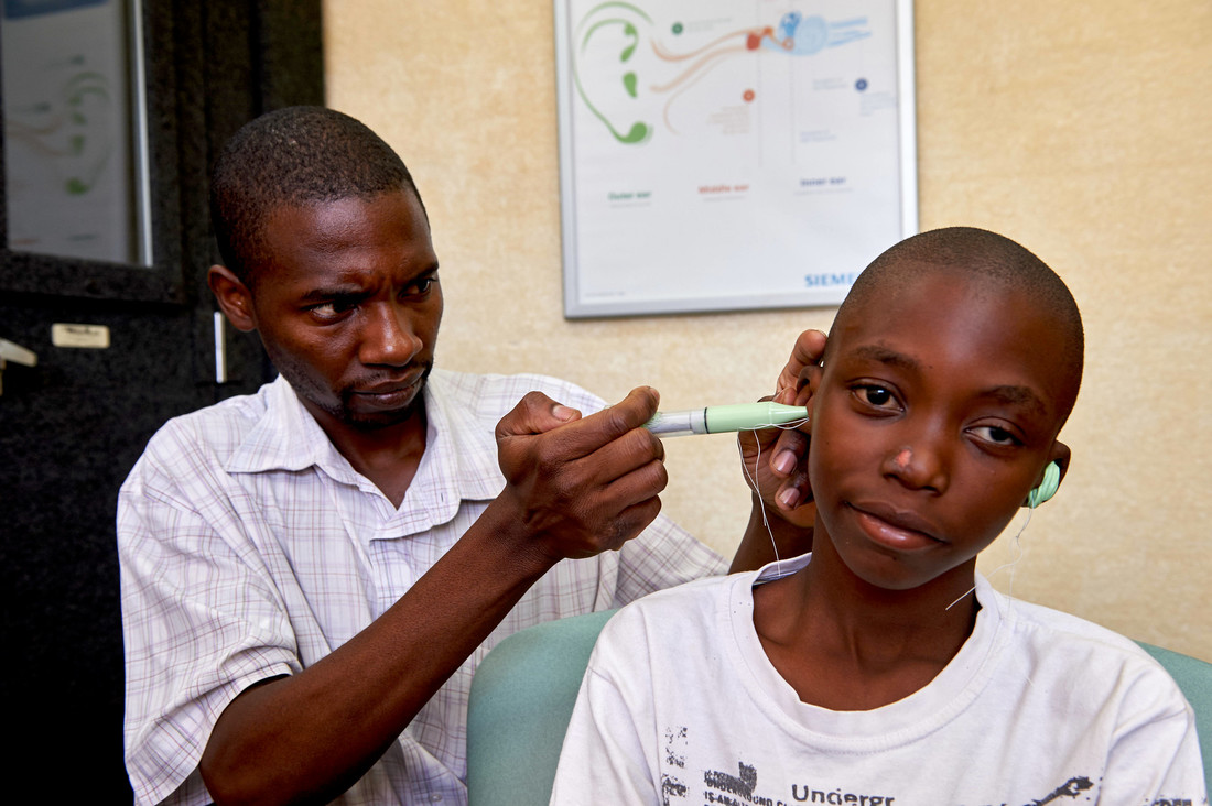 Patson Sakala, hearing instruments specialist at Beit CURE Hospital, creates ear moulds for Balika's new hearing aids.