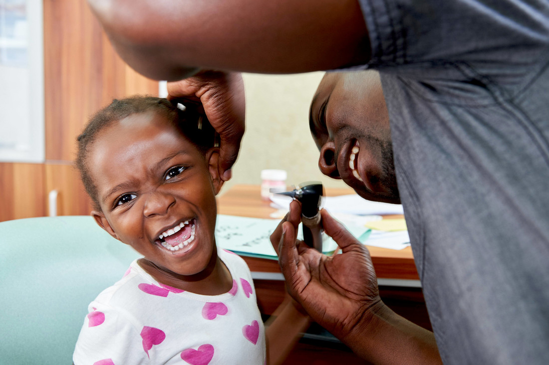 Audiologist, Alfred Mwamba, examines Chimya (4) at Beit CURE Hospital, in Zambia