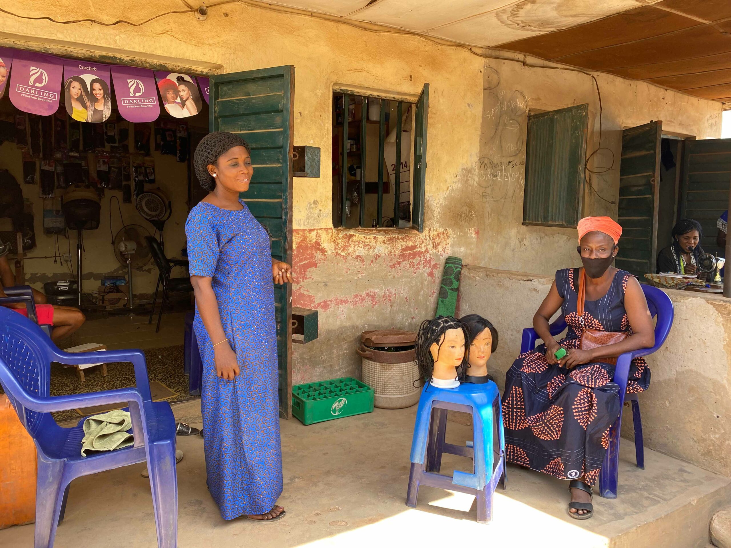 A woman at her hair salon with a male client