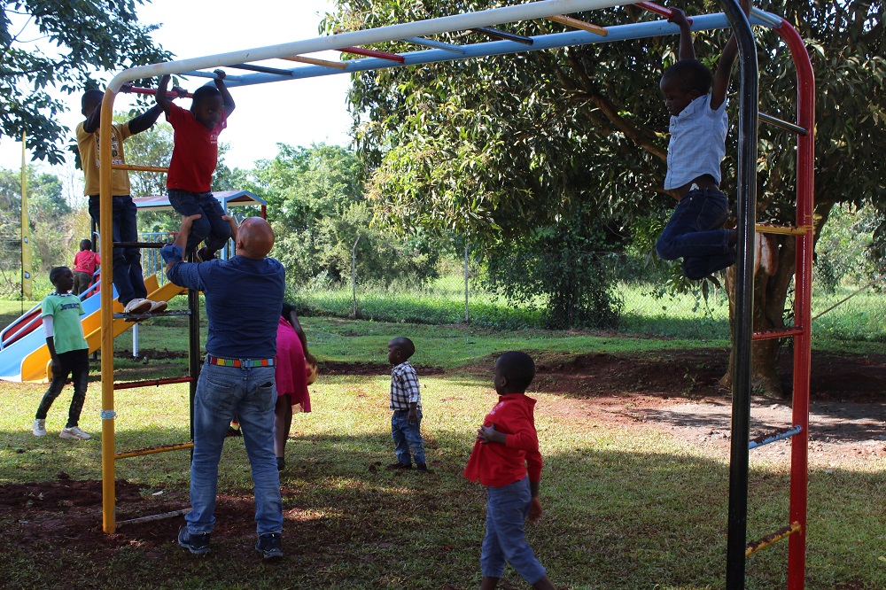 Children at CoRSU Hospital playing with new play equipment.