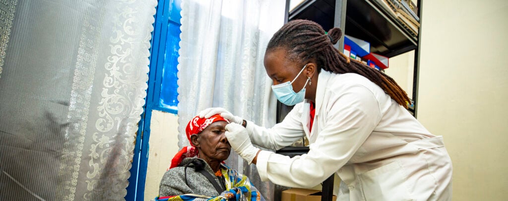 Nurse Peace removes Velena's eye patch after cataract surgery.