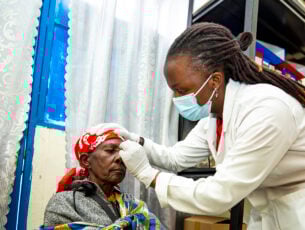 Nurse Peace removes Velena's eye patch after cataract surgery.