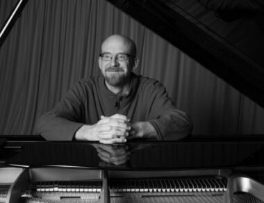 James Williams sitting behind a piano.