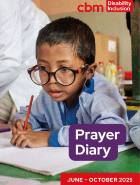 Cover of CBM UK Prayer Diary with a young boy with large glasses.