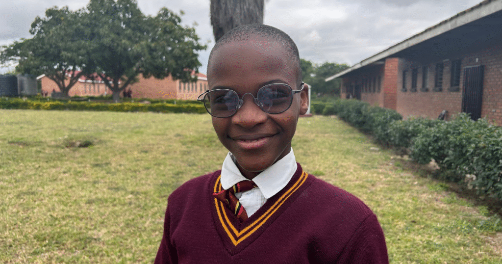 Tinotenda wearing glasses