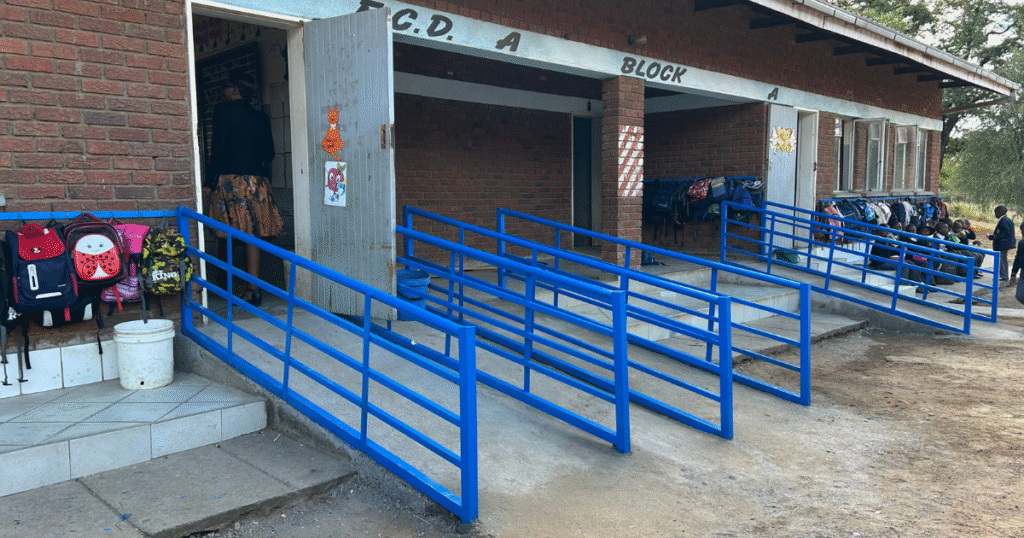 A school with blue railings for wheelchairs.
