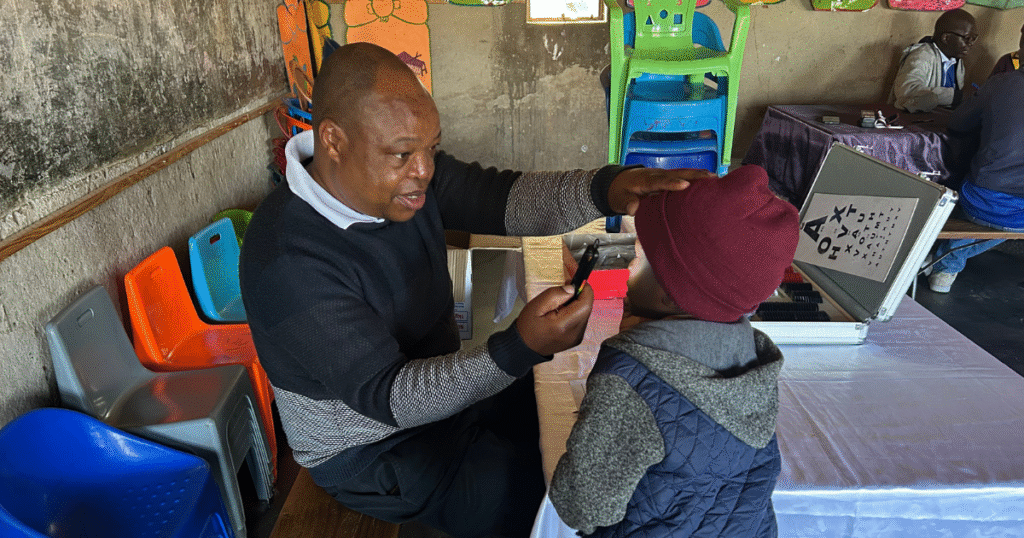 A health worker using the arclight to test a child's eyes.