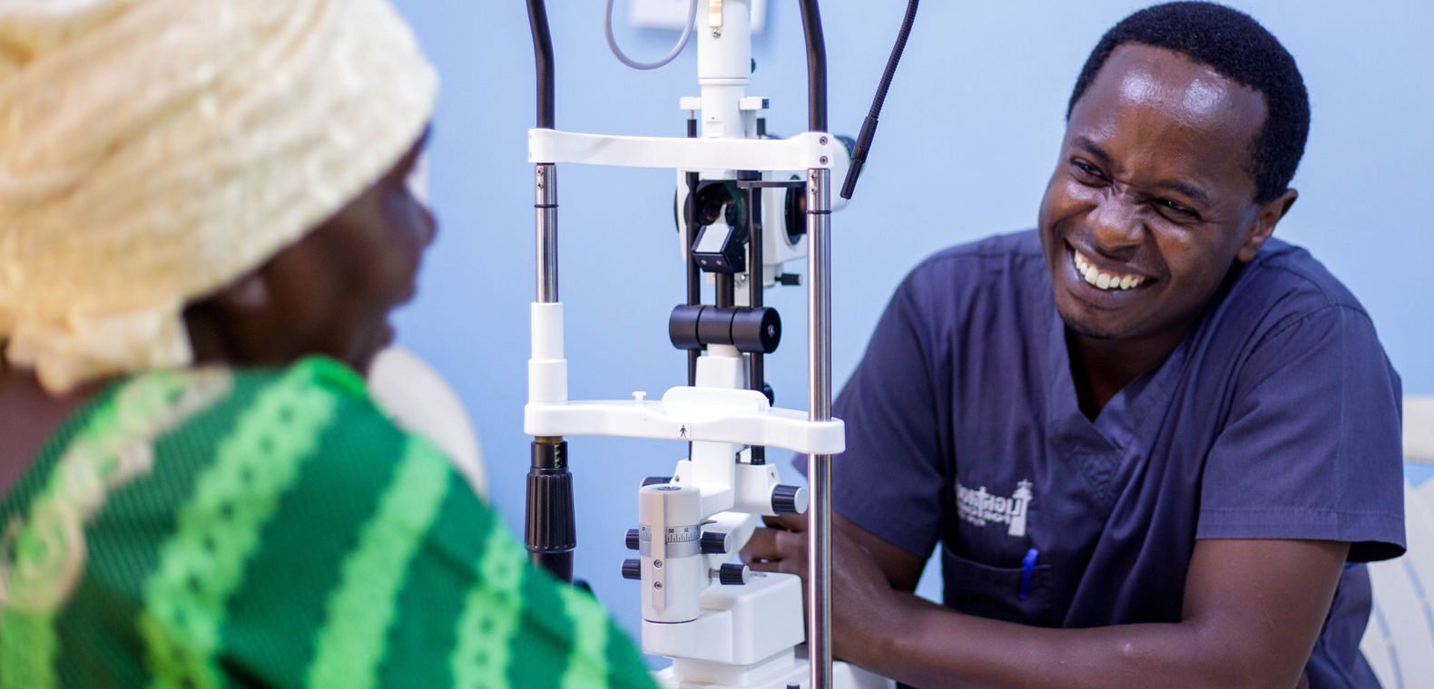 Dr Chege with a patient in hospital in Malawi