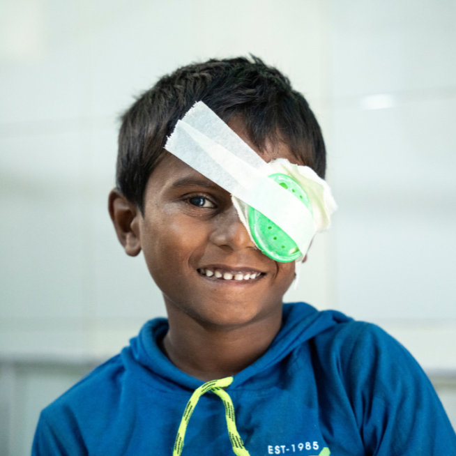 A boy from nepal wearing an eye patch after cataract surgery