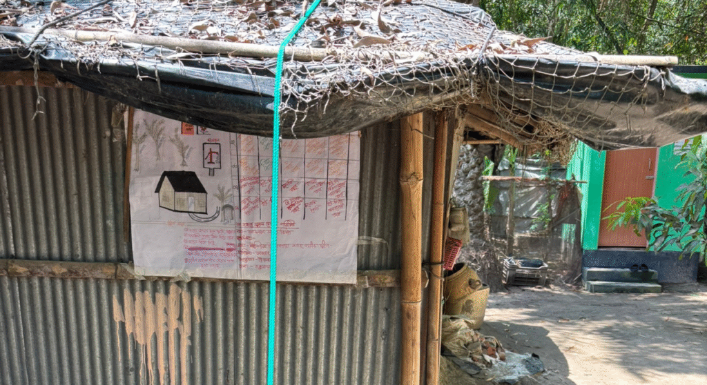 A green rope ties down a roof.
