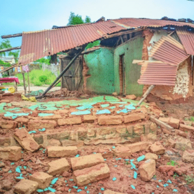 A brick, wood and corrugated iron hut that is falling down and have been severely damaged.