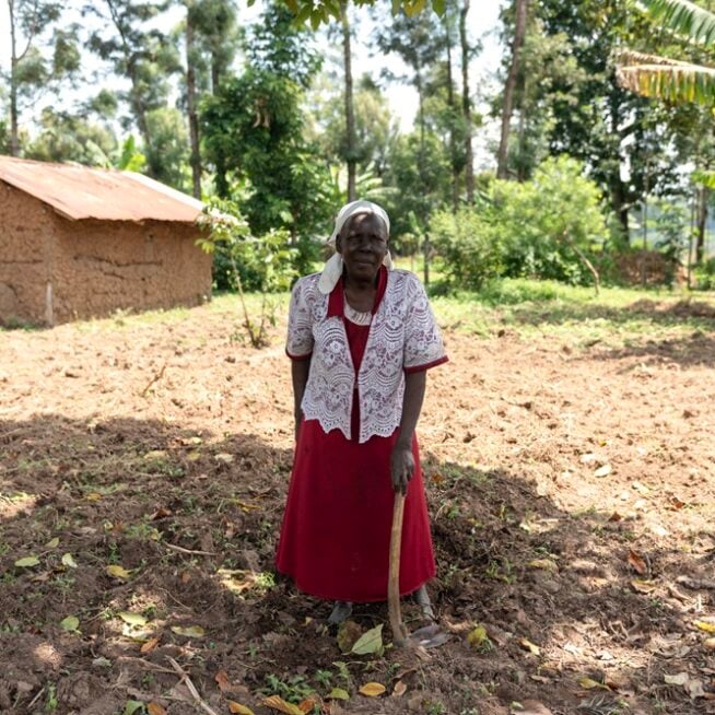 Benedetta standing in her home village in rural Kenya.