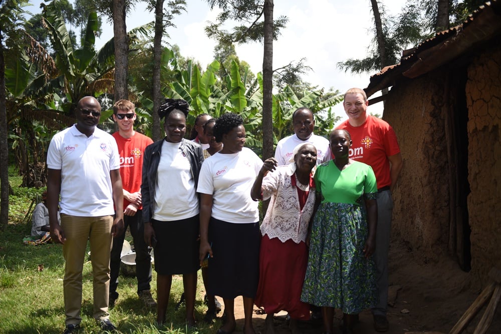 Members of CBM stand with Benedetta in rural Kenya.