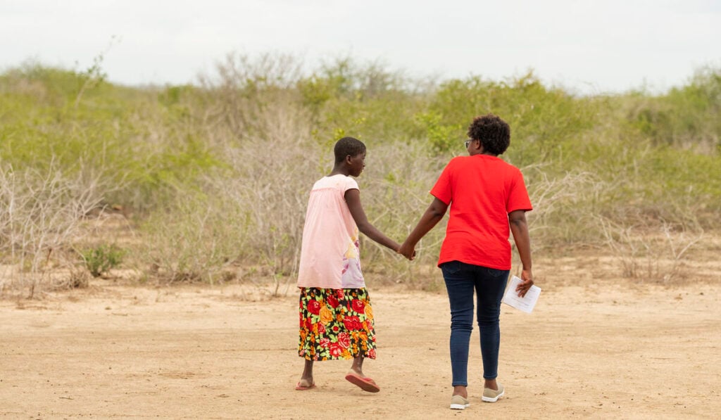 A participant and a CBM staff member talk together as part of an Inclusive Communities Project in Kenya.