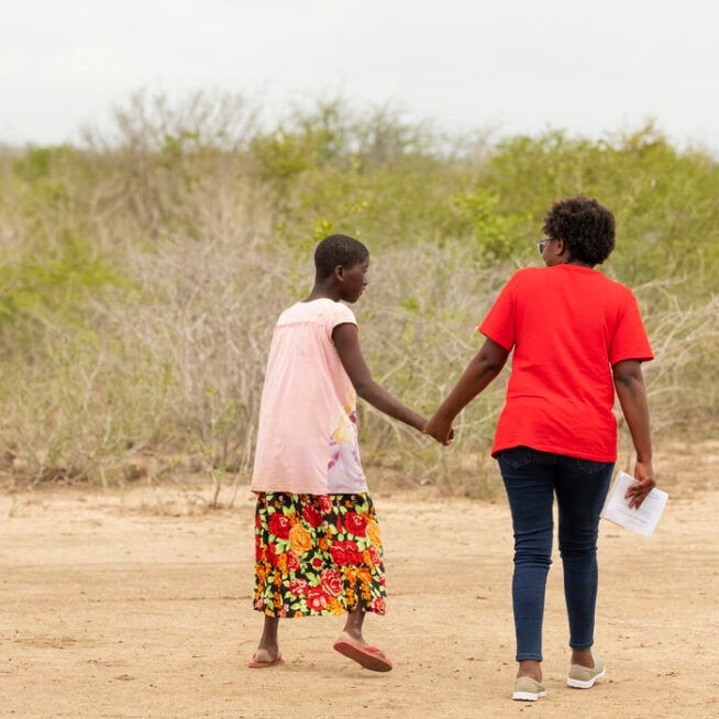 A participant and a CBM staff member talk together as part of an Inclusive Communities Project in Kenya.