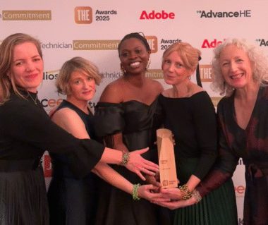 Five people hold the Times Higher Education Award for a girls' inclusive education collaboration. Behind them are the logos of the sponsoring organisations.