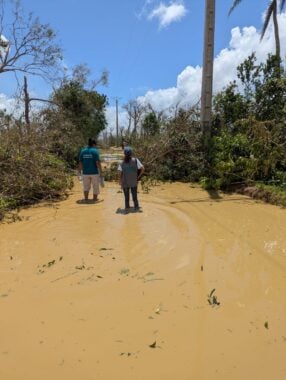 Relief workers standing in a flooded area caused by Cyclone Gezani
