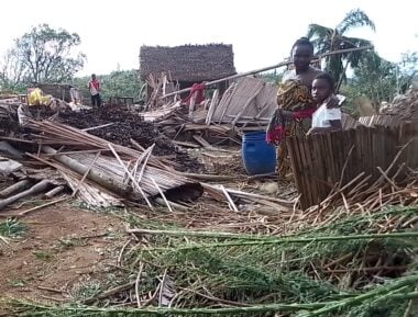 A mother and a daughter standing by the damage caused by cyclone gezani