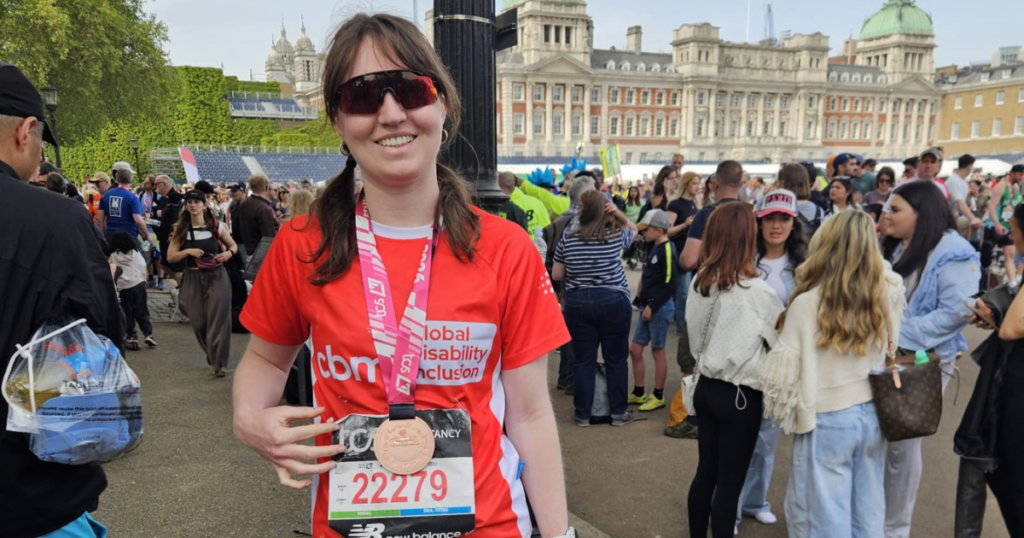 Amelia wearing her london marathon medal